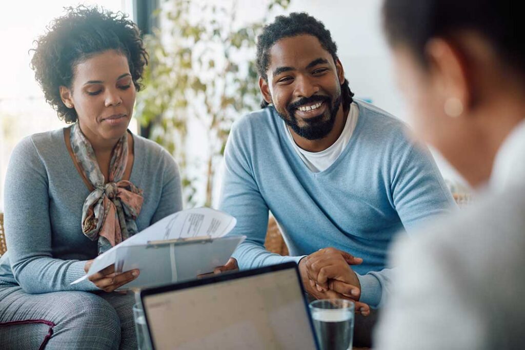 A local family sits together at the kitchen table, reviewing documents and discussing financial plans.
