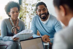 A local family sits together at the kitchen table, reviewing documents and discussing financial plans.